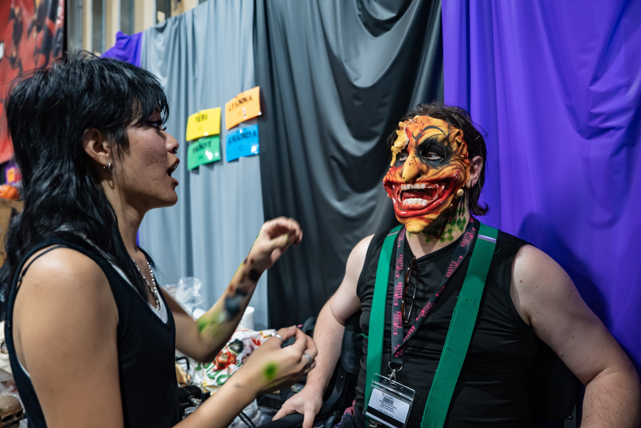 A student applies makeup to a Knott's Scary Farm actor.