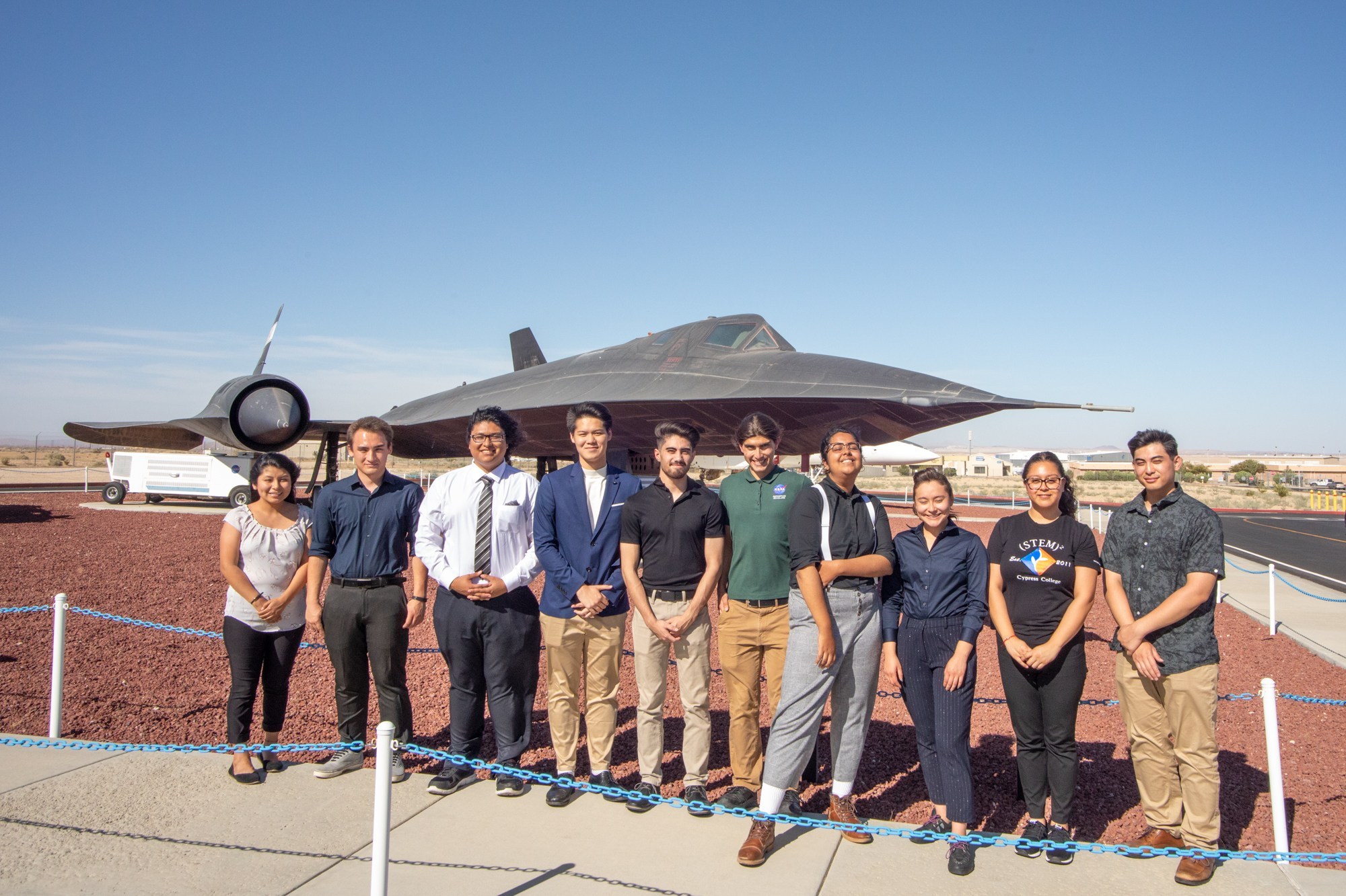 Students standing in front of a plane