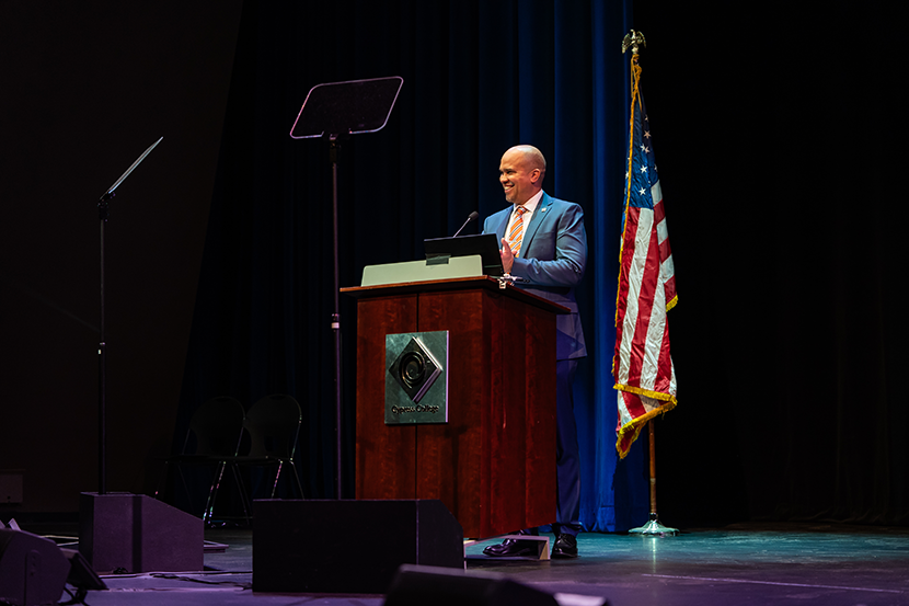 Cypress College President Scott Thayer on stage at a podium and microphone on opening day