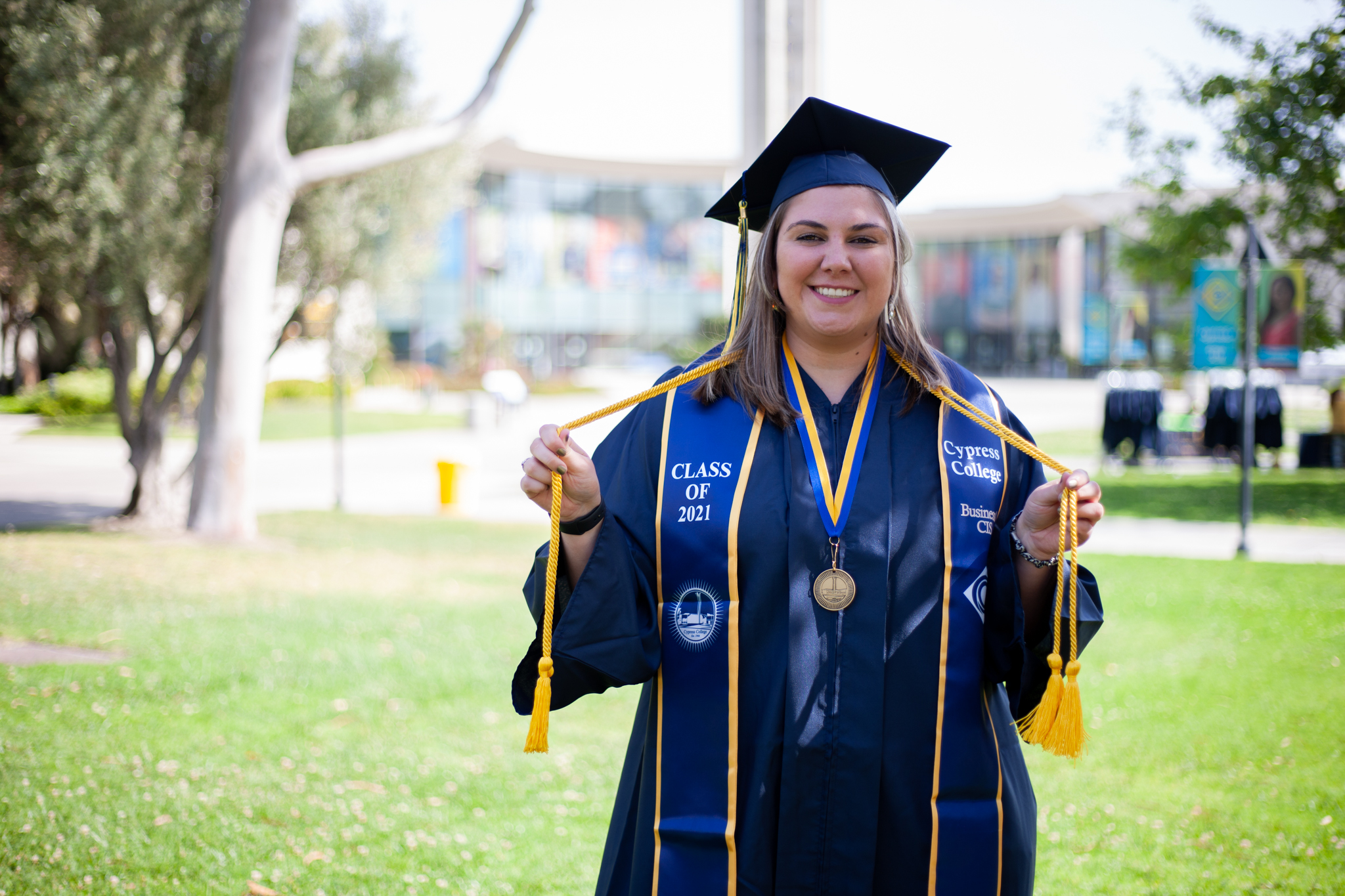 Business/CIS student Jacklyn Williams poses with graduation regalia on Cypress College campus.