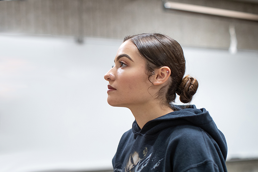 Female student wearing a sweatshirt gazing in front of her