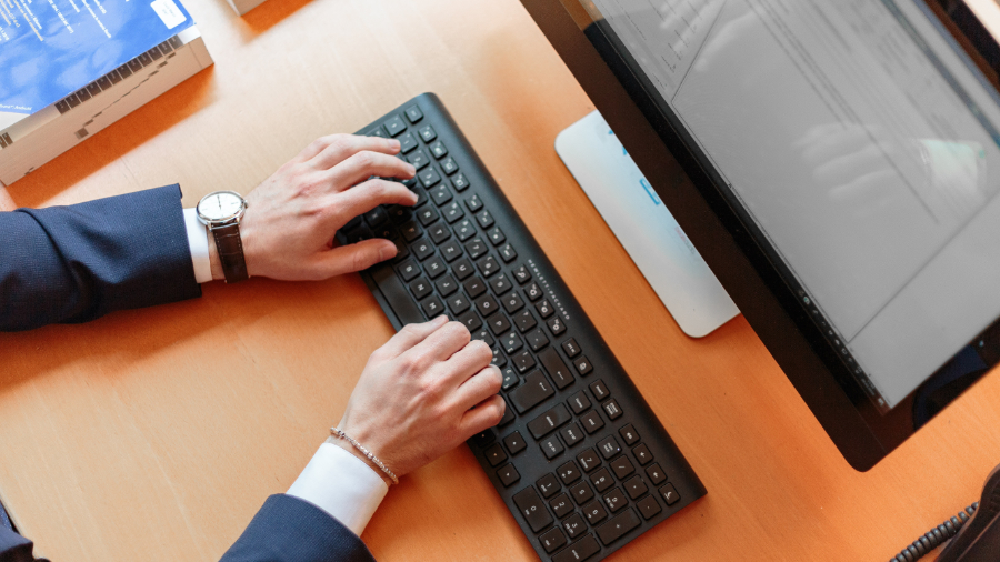 Person typing on computer keyboard