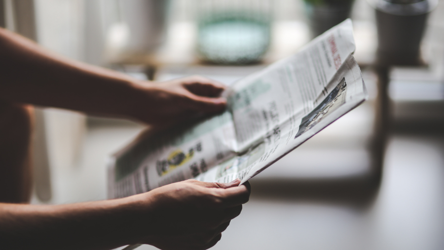 Person holding newspaper