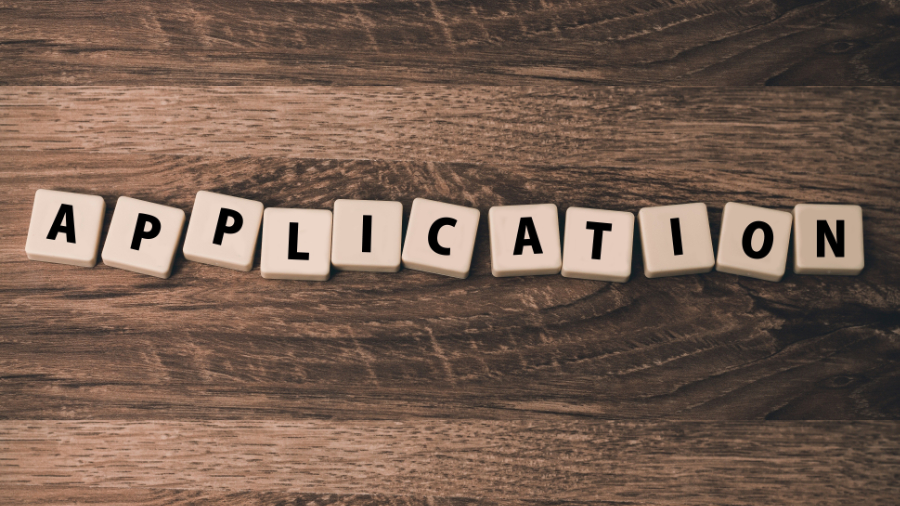 Board game tiles spelling out "Application"
