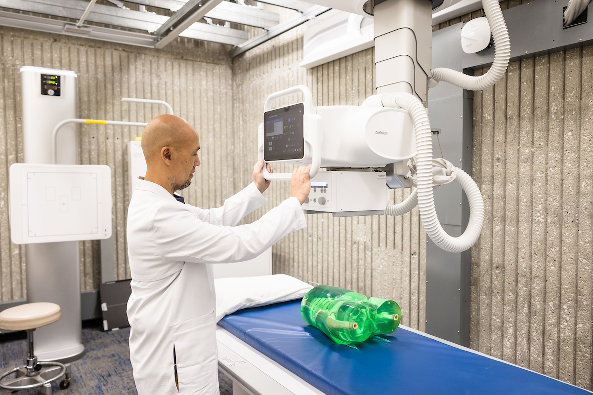 Michael Frianeza uses the scanning equipment from a new X-ray machine