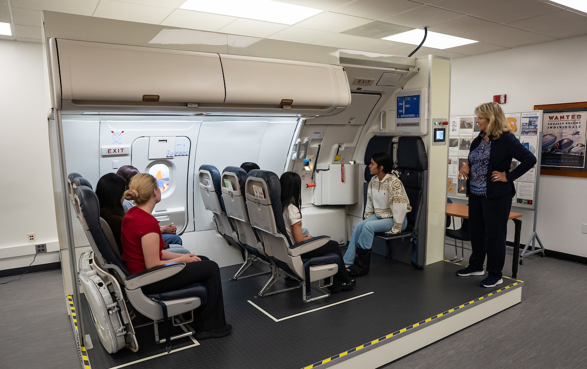 Students sit in a simulated airplane cabin
