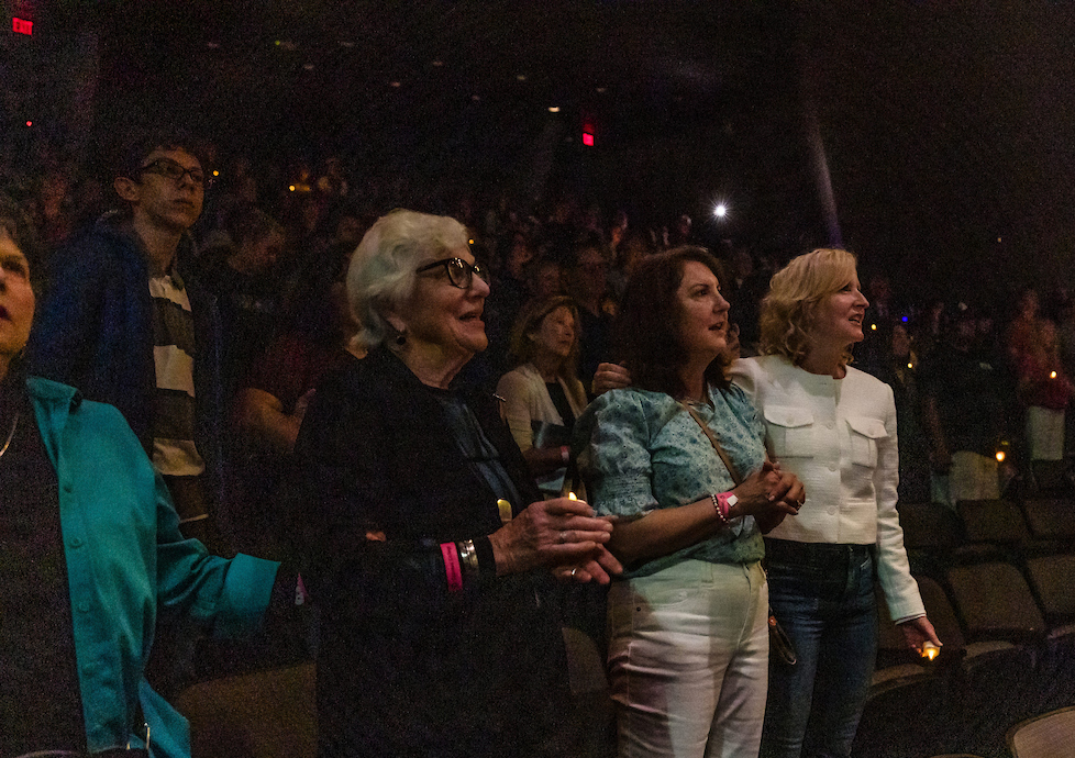 Audience members held candles in the theater for the 10th Annual Yom HaShoah Holocaust Remembrance event.