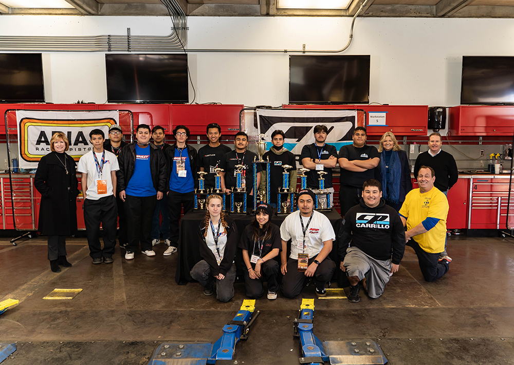 Cypress College administrators, faculty, pose with local high school students and the trophies they won in the Auto Skills and Career Fair.