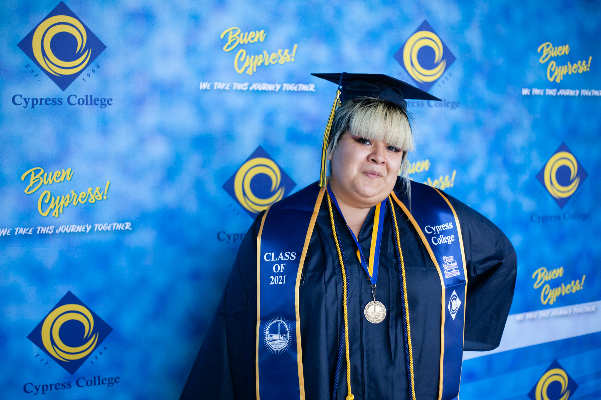 Culinary Arts student Alexandra Camacho poses in front of a blue background.