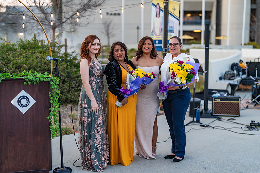 Women standing together holding flowers