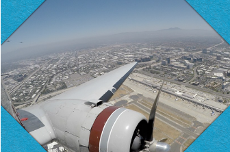 Airplane wing and ground below