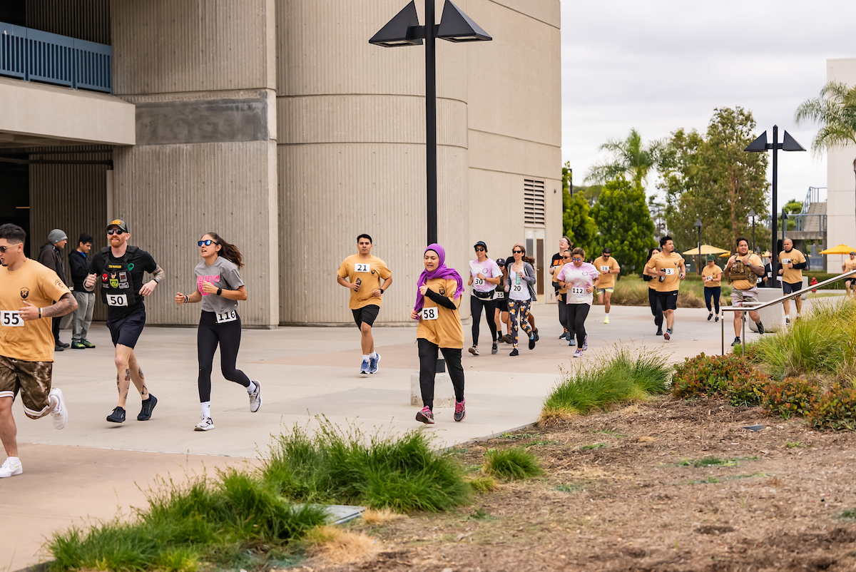 Students, faculty, and staff run through the campus