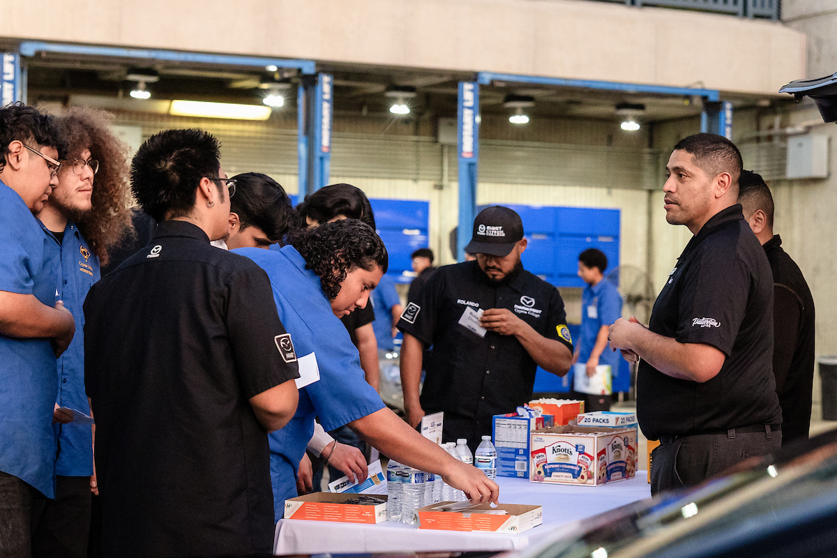 Auto Tech students interact with a vendor at the OCADA career fair