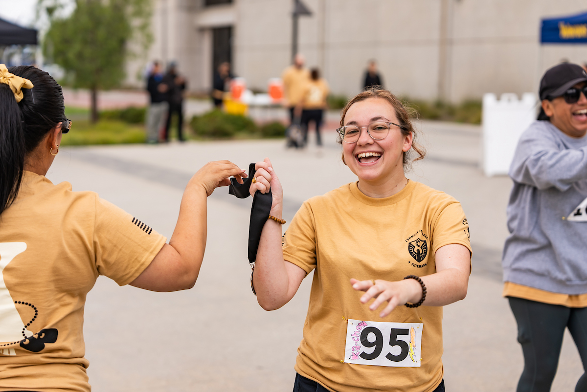 A finisher holds a medal