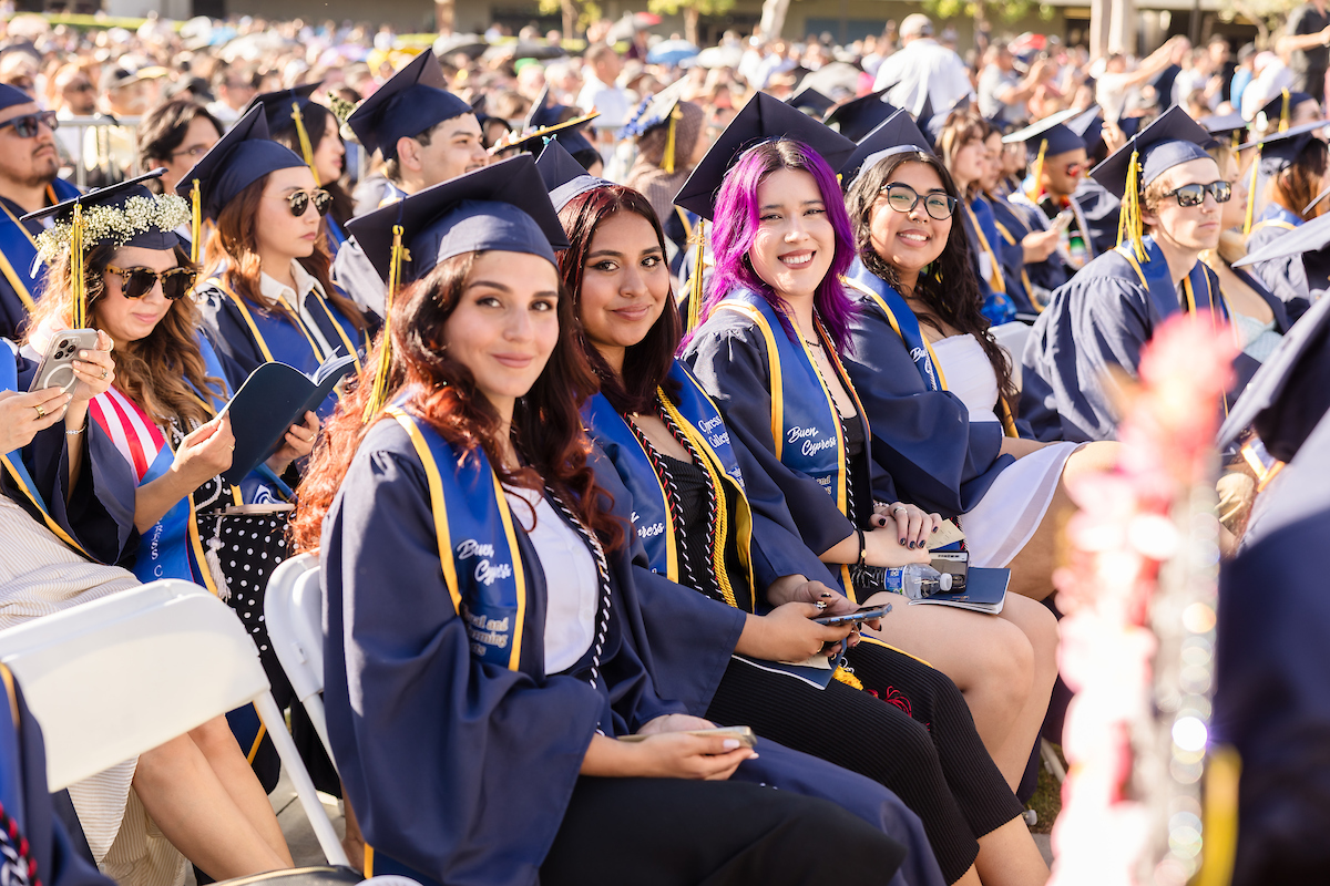 Graduate candidates sit smiling in the audience of the 58th Cypress College Commencement Ceremony
