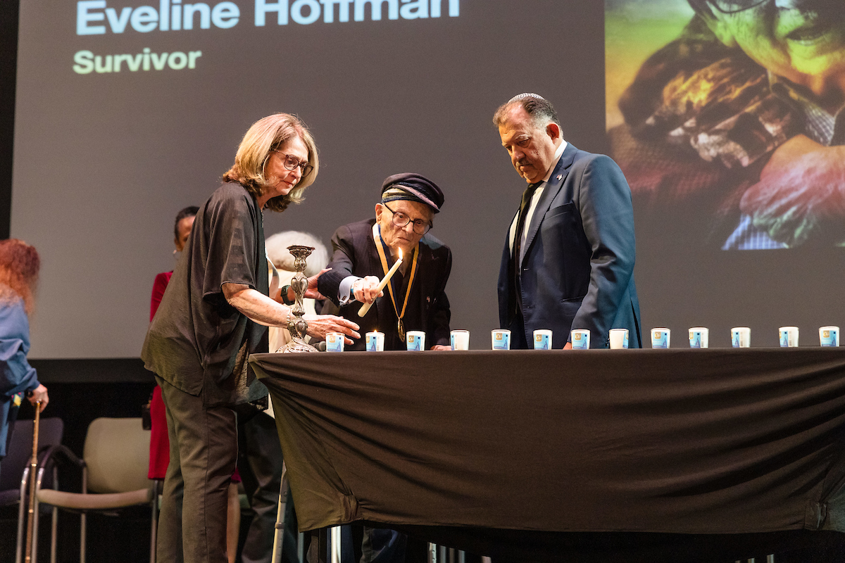 Dr. Jacob Eisenbach lights candles onstage