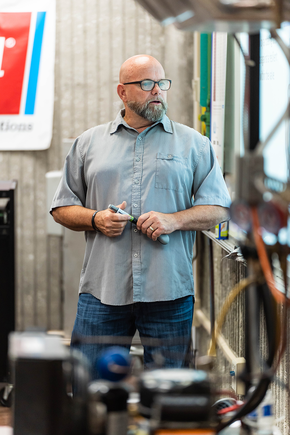 John Lasater looks on to a screen as he teaches students in Air Conditioning and Refrigeration. 