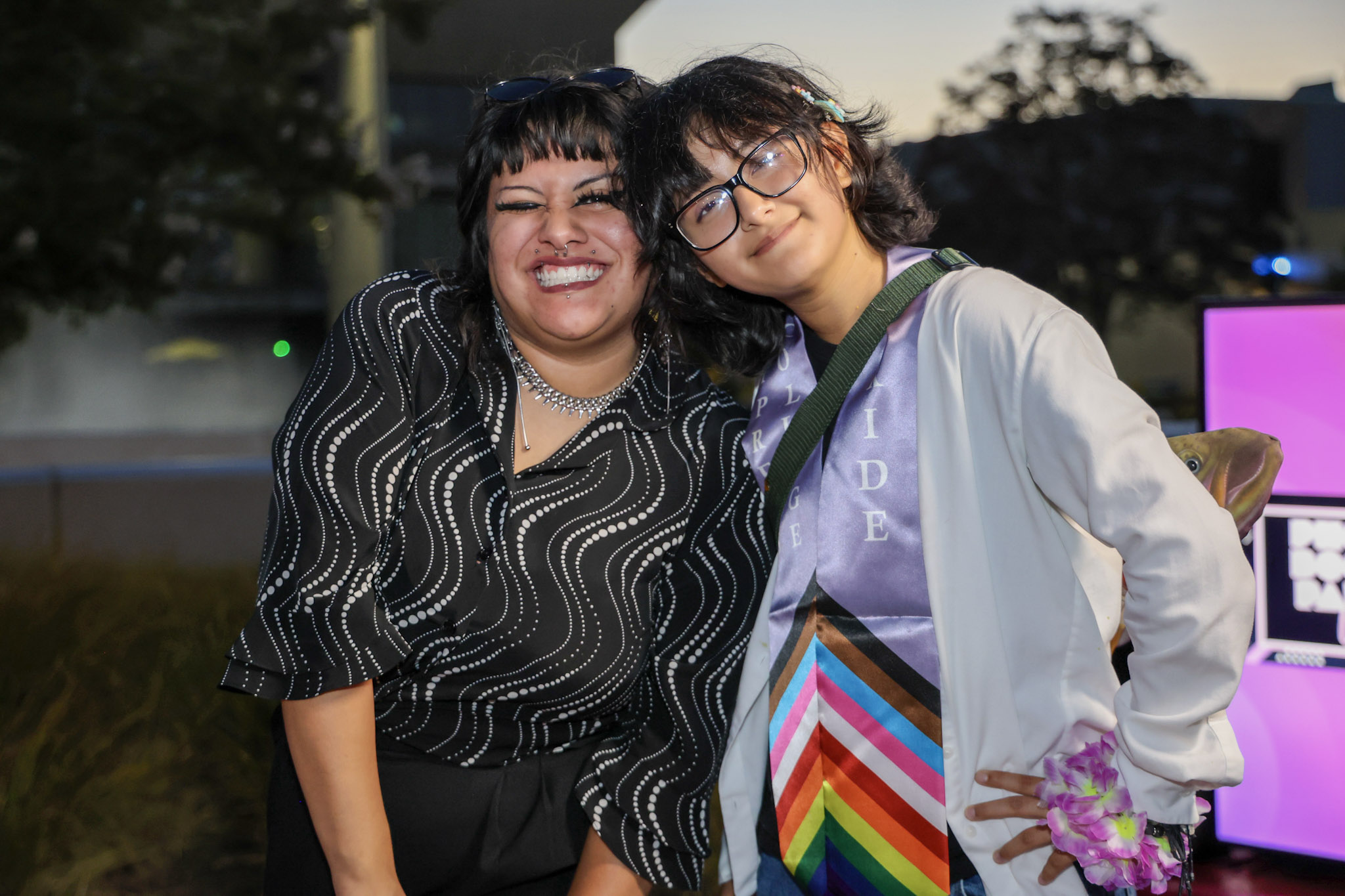 Two students smile for the camera