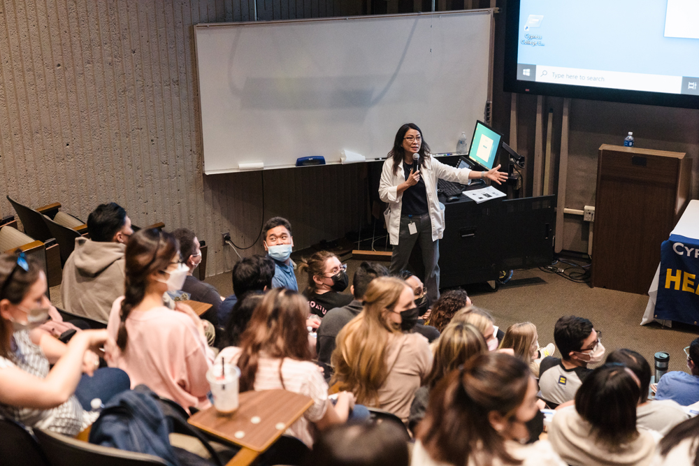 Nursing students sit in audience of classroom for a zoom workshop.