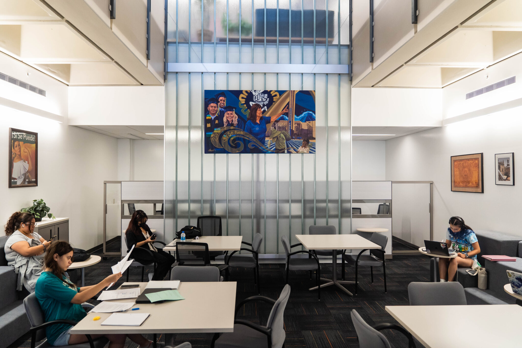 room with students studying, photos of Puente on the wall