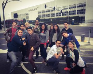Students pose in front of the SpaceX building