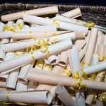 A basket of ribbon tied scrolls.