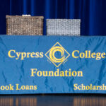 Cypress College Foundation table with two baskets sitting on top.