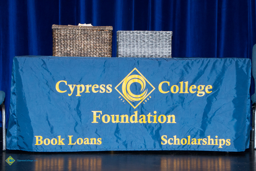 Cypress College Foundation table with two baskets sitting on top.