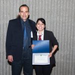 Eldon Young standing with a scholarship award recipient.