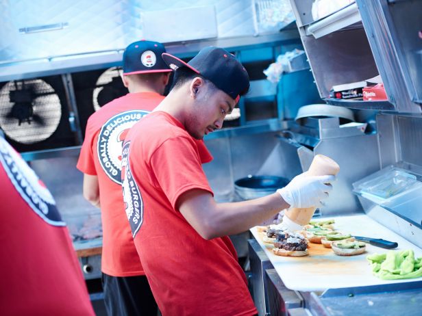Men preparing food inside food truck