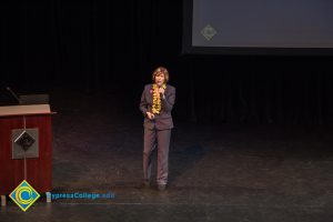 Dr. JoAnna Schilling, in a brown pant suit, speaks on stage at the 2018 Connect2Careers & Majors2Careers event.