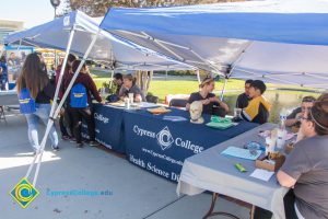 Health Science booth with staff and students at the tables.