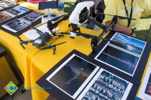 Table with drones and drone photos on display.