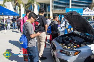 Students looking at cars on display at the Connect2Cypress & Majors2Careers event.