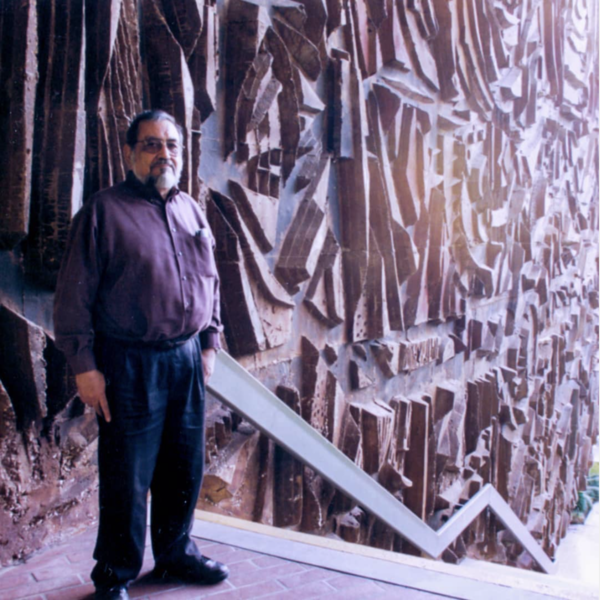 Sergio O'Cadiz standing next to the concrete sculpture he designed.