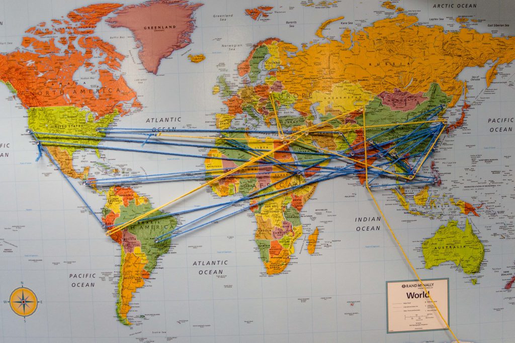 Map of the world with strings going to various places