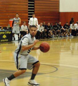 Basketball player on court with team in background