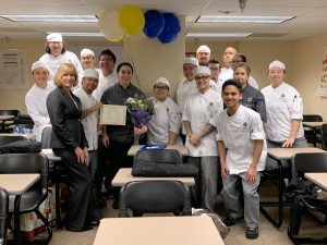Culinary students gather around instructor Chef Amanda Gargano