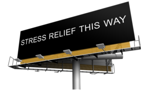 Black billboard image with the words "Stress Relief This Way" in white letters.