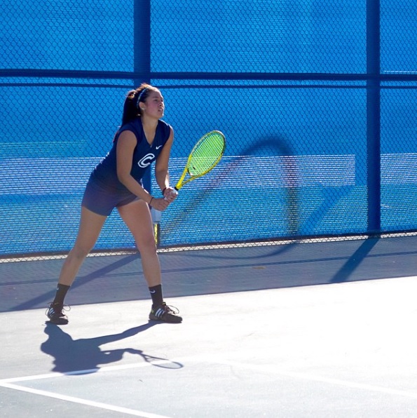 Girl holding a green tennis racket